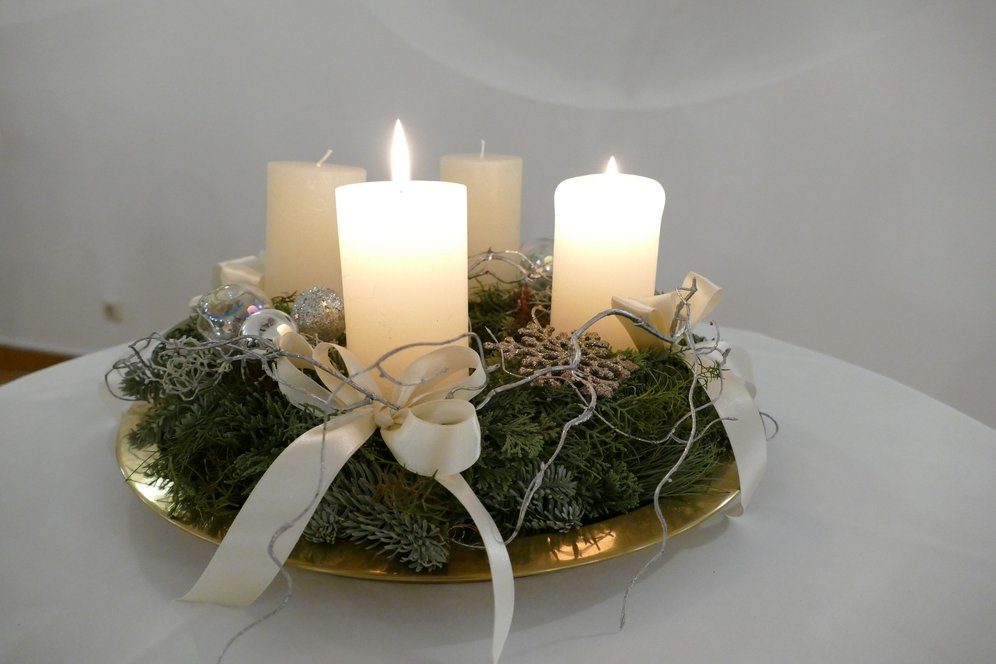 Zwei Kerzen brennen am Adventkranz.